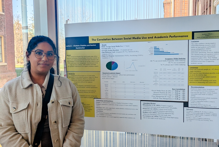 A student stands infront of her poster presentation on social media use and academic standing